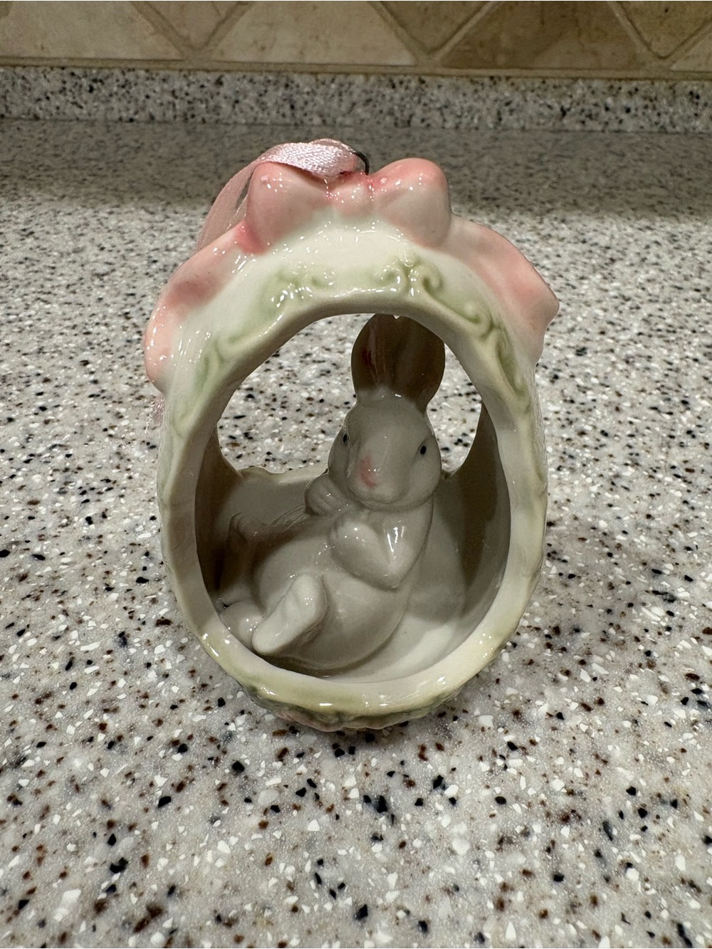 Porcelain Easter ornament featuring a small seated rabbit inside